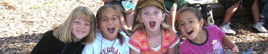 Girls sitting on outdoor bench, excited to be in nature