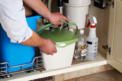 A compost bin stored under the sink