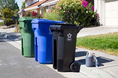 Used Oil and filters in proper containers on curb, Set Out next to bins in neighborhood