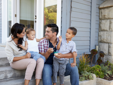 Family in front of house