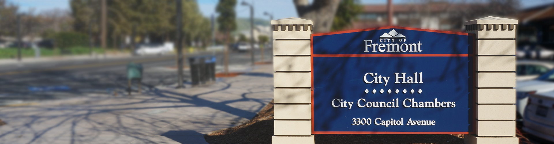 City Hall sign near sidewalk and street