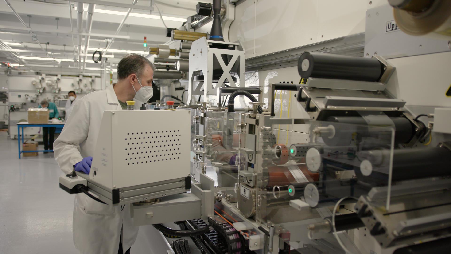 Man working on advanced manufacturing machinery