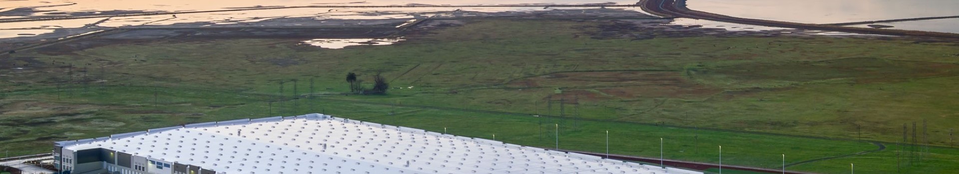 View of industrial building roof and San Francisco Bay's water