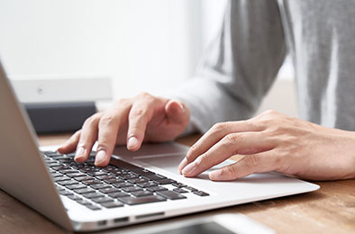 person typing on laptop