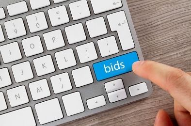 keyboard with 'bids' in text button and finger clicking