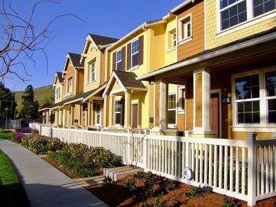 Row of Condos with fence and sidewalk