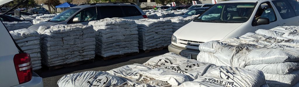 Compost Giveaway Day stacks of compost and line of cars