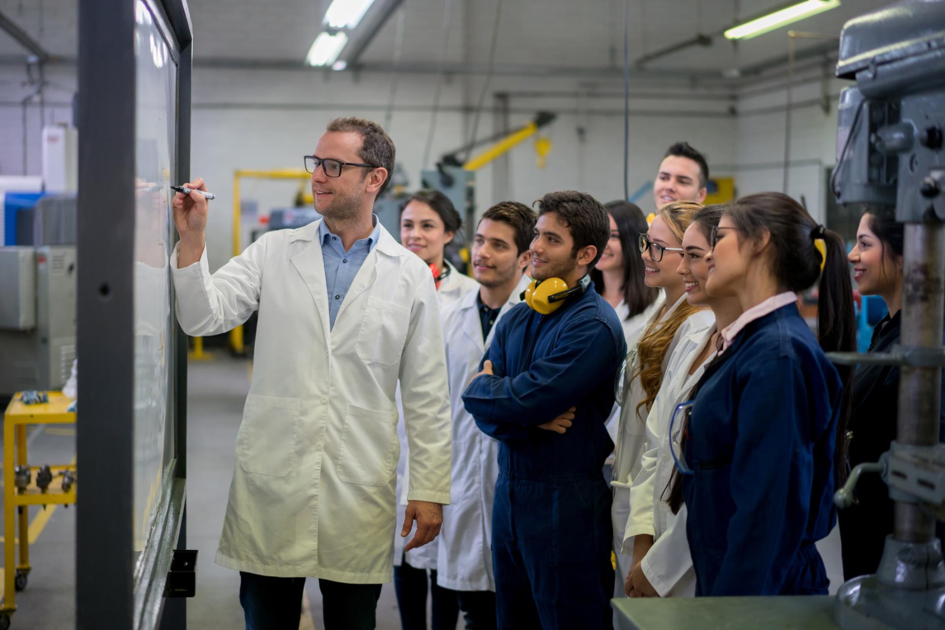 man with white coat and apprentices or trainees