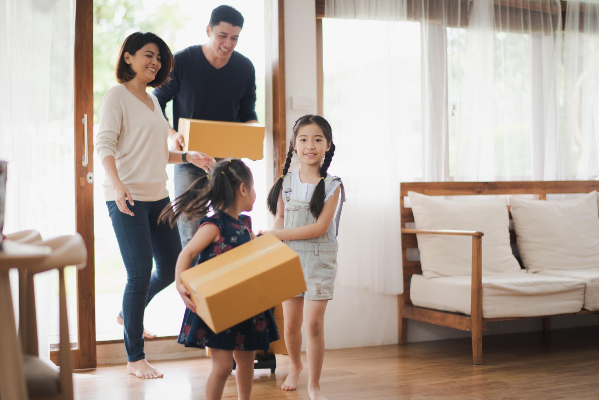 Photo of a family with moving boxes