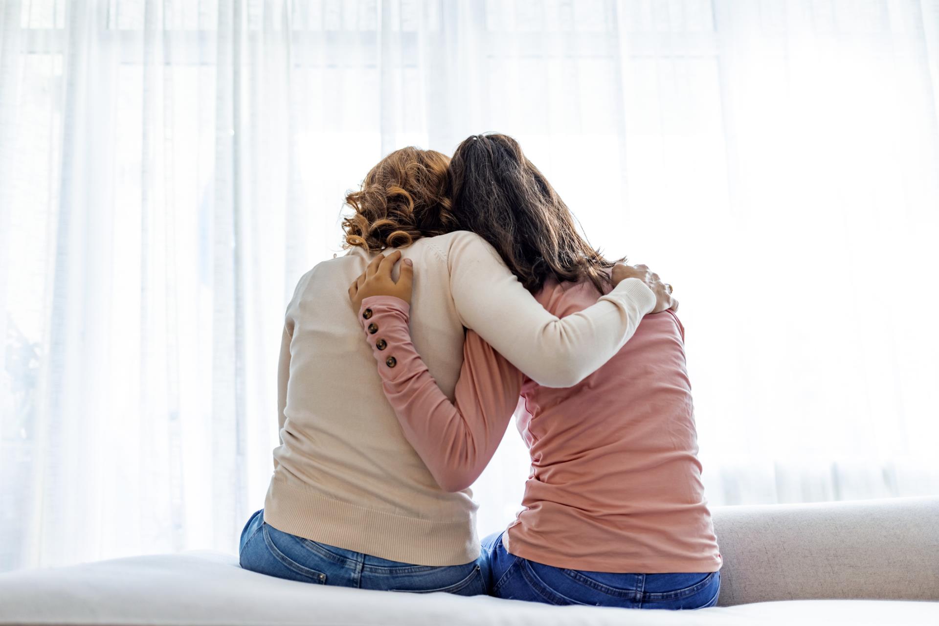 Photo of a mother and daughter hugging