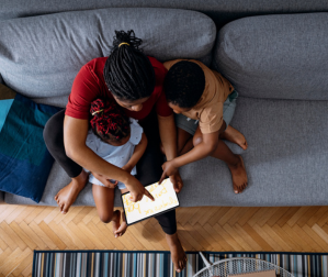 Woman with two children on the couch