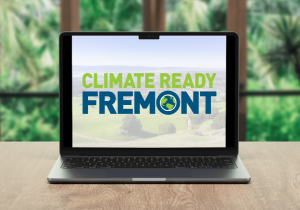 laptop sitting on table with Climate Ready Fremont on screen