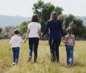 Family walking in a grassy field